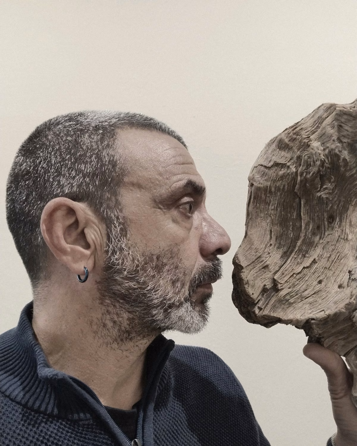 Nikolas Sideris face to face with a piece of Aegean driftwood in his studio